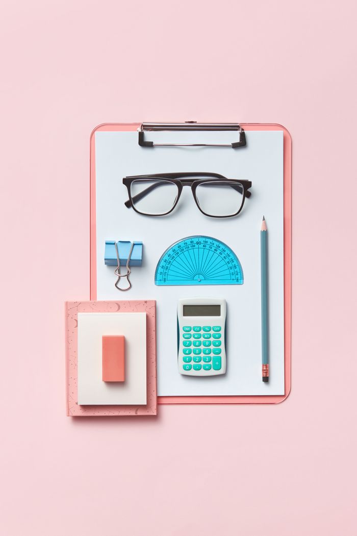 service-06 Modern flat lay featuring office supplies like calculator, clipboard, and glasses on a pink surface.